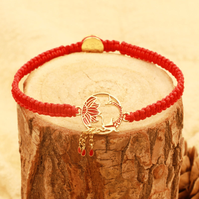 Tibetan Red String Koi Fish Bracelet – red cord on wooden tree stump, gold koi medallion with red enamel, dangles