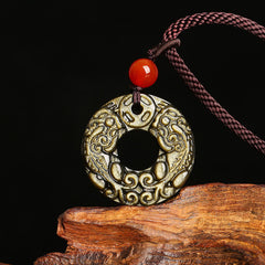 Peace Buckle PiXiu Necklace – Gold sheen obsidian carved PiXiu disc with red bead on purple rope, wood display