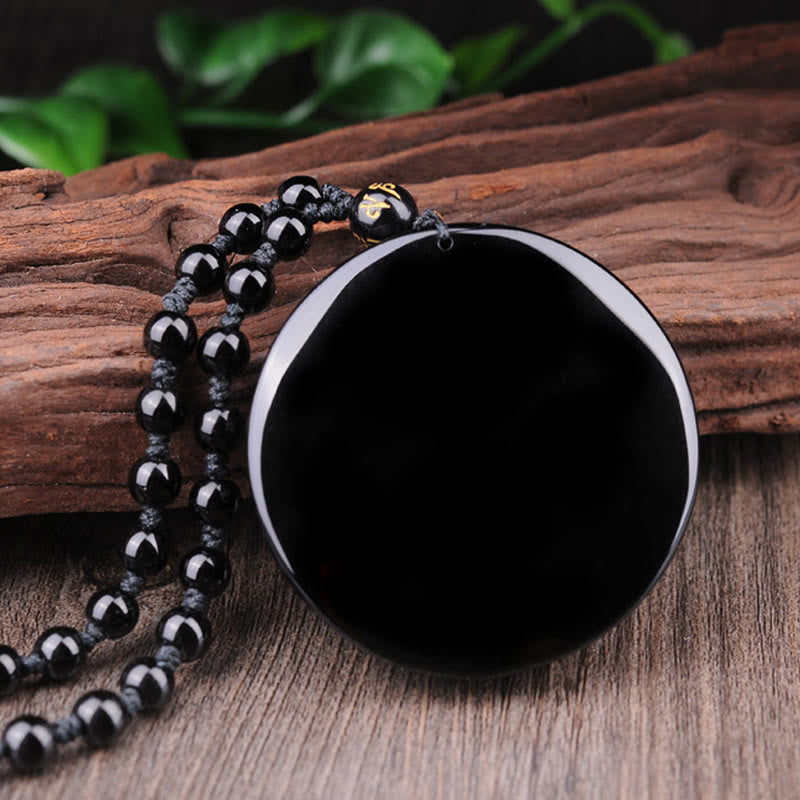 Bagua Dragon Phoenix Obsidian Pendant – Mirror-polished obsidian disc on wood, serene