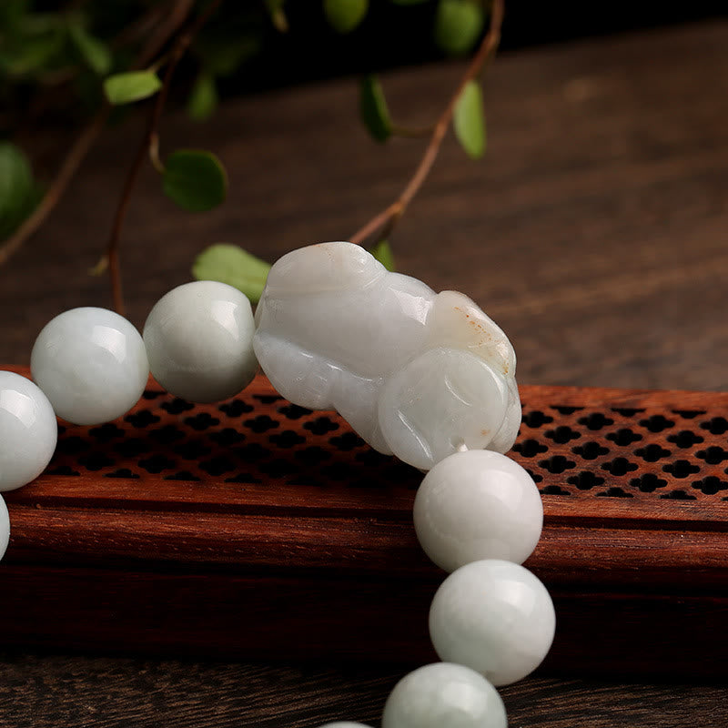 Jade PiXiu Bracelet – Extreme close-up of jade PiXiu carving on wood lattice, wealth talisman detail