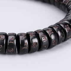 Coconut Shell Om Mani Padme Hum Bracelet – polished black mantra beads with copper inlay close-up, shallow depth macro side angle