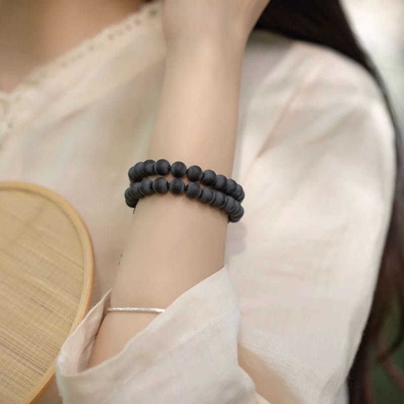 Tibetan Cypress Bodhi Lotus Bracelet - double-layer matte black beads on wrist with bamboo fan, bohemian