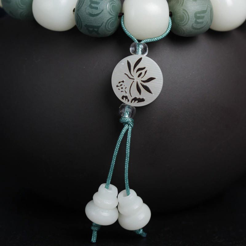 White Bodhi Seed Om Mani Padme Hum Bracelet – Tassel detail with gourd beads on black, spiritual charm
