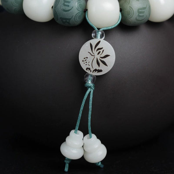 White Bodhi Seed Om Mani Padme Hum Bracelet – Tassel detail with gourd beads on black, spiritual charm