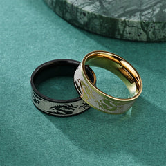 Dragon Titanium Steel Ring – Black and gold pair on teal surface with marble, Striking