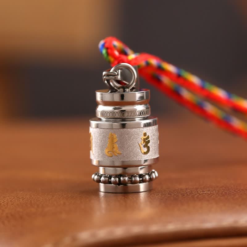 Om Mani Padme Hum Amulet – Low angle, five-color cord, gold mantra, steel pendant