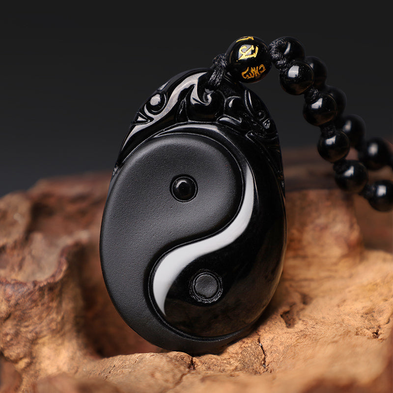 Black Obsidian Yin Yang Pendant Necklace – Black obsidian Yin-Yang necklace with gold inscribed beads, wood display