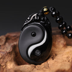 Black Obsidian Yin Yang Pendant Necklace – Black obsidian Yin-Yang necklace with gold inscribed beads, wood display