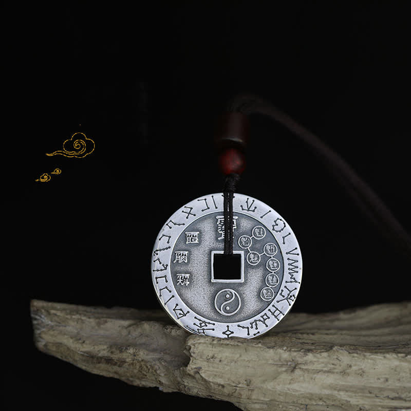 Bagua Yin Yang Obsidian Necklace - engraved coin pendant with star symbols on driftwood, black backdrop