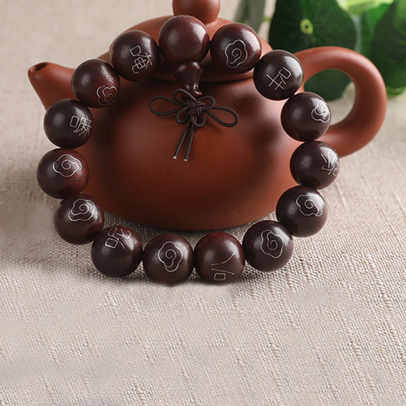 Sterling Silver Sandalwood Mantra Bracelet – draped over terracotta teapot with greenery, mindfulness jewelry