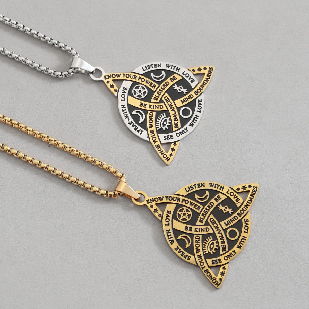 Celtic Moon Star Necklace – close-up gold and silver triquetra pendants on gray, engraved amulet