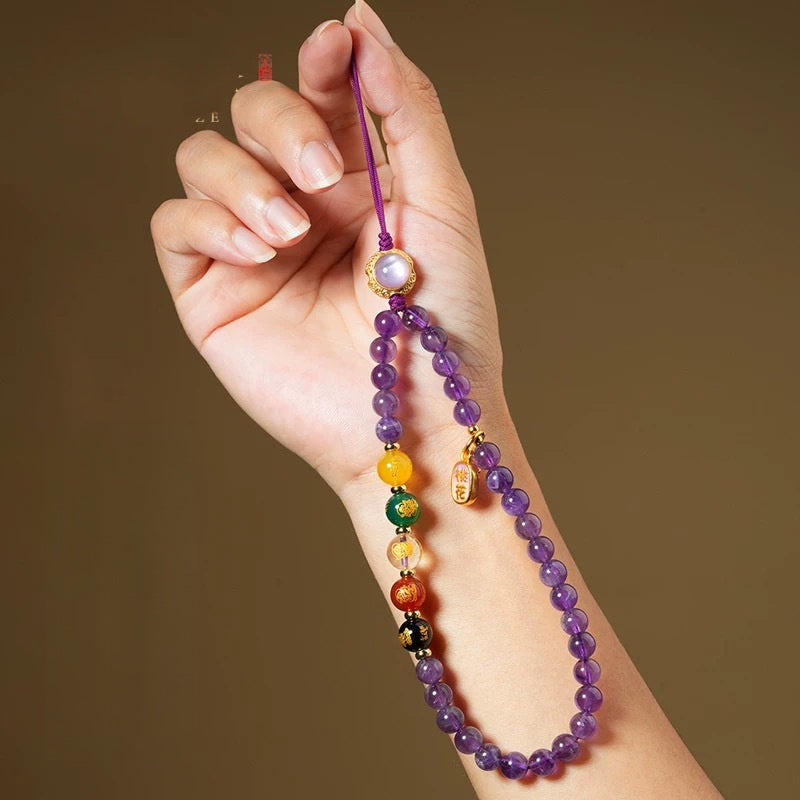 Amethyst Phone Charm – hand holding strap with moonstone top and colorful beaded tassel