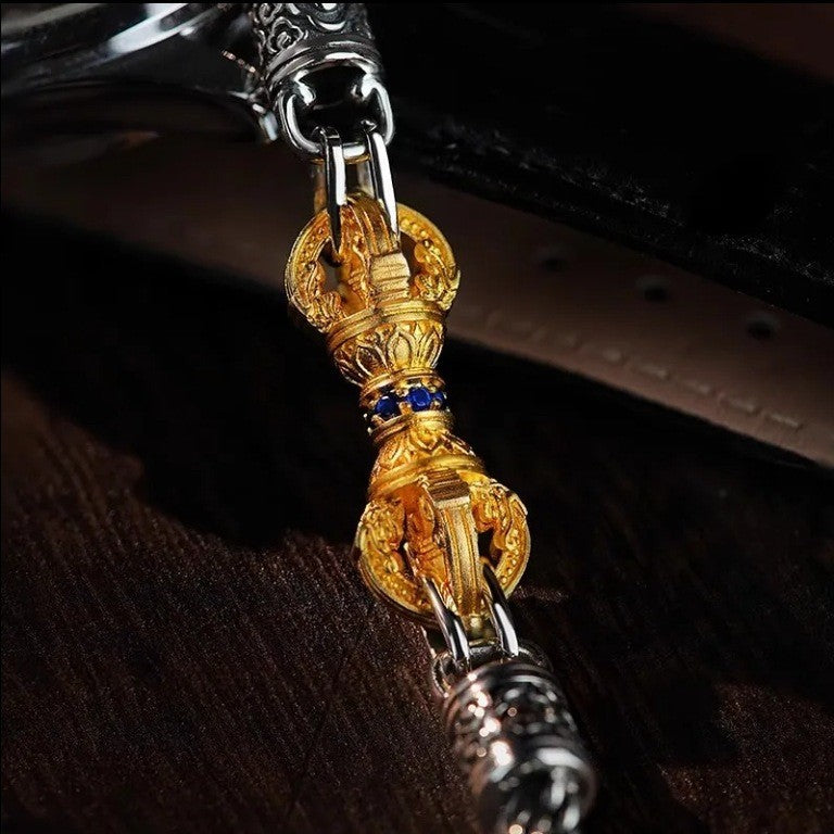Vajra Bracelet – detailed view of gold vajra centerpiece on dark leather, silver connectors visible