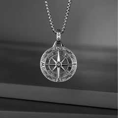 Brass Compass Necklace – detailed compass rose pendant on chain dark wood background, protection amulet