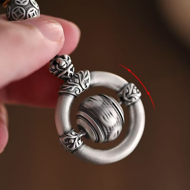 Mantra Keychain – spinning bead motion demonstration with red arrow, rotating prayer wheel