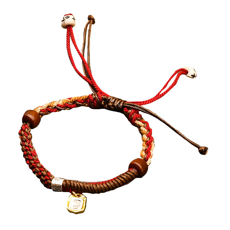 Tibetan Cord Bracelet – red cord on white background showing adjustable knot design, Tibetan jewelry