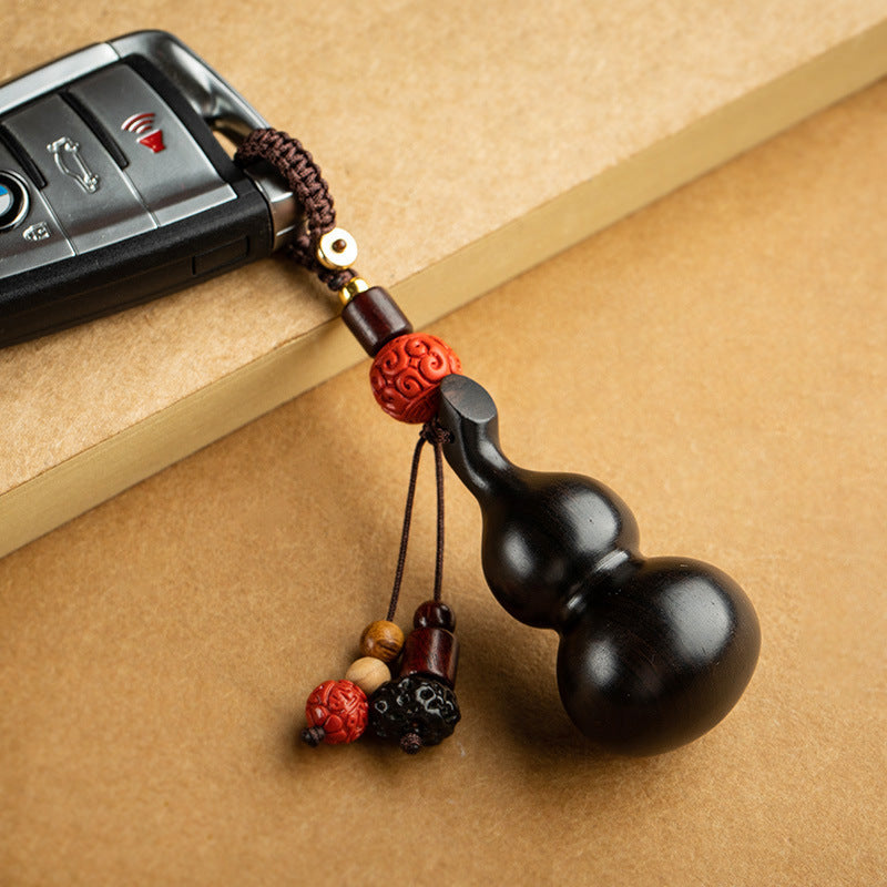 Sandalwood Gourd Keychain – dark gourd attached to car key fob with red carved bead charm