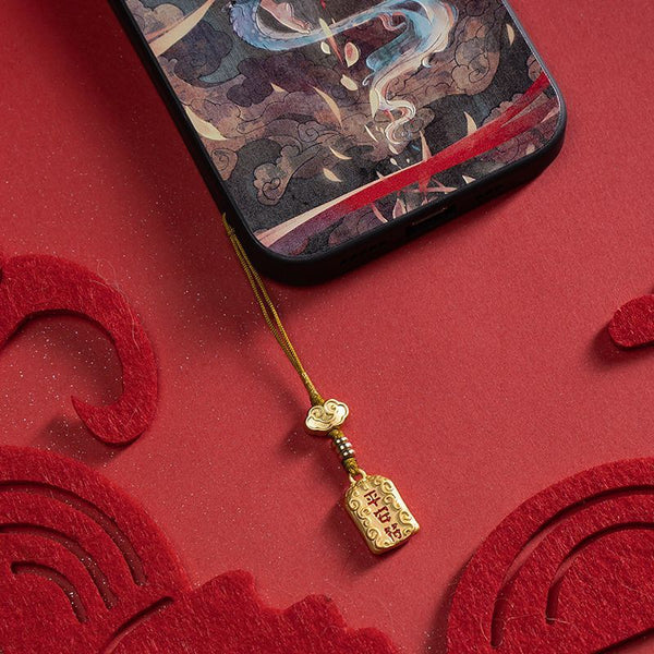 Brass Feng Shui Good Luck Keychain - gold peace charm hanging on smartphone, red festive background