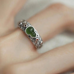 Jade Gourd Ring – detailed close-up of green jade gourd in silver setting with red dot accents, hand model, auspicious jewelry