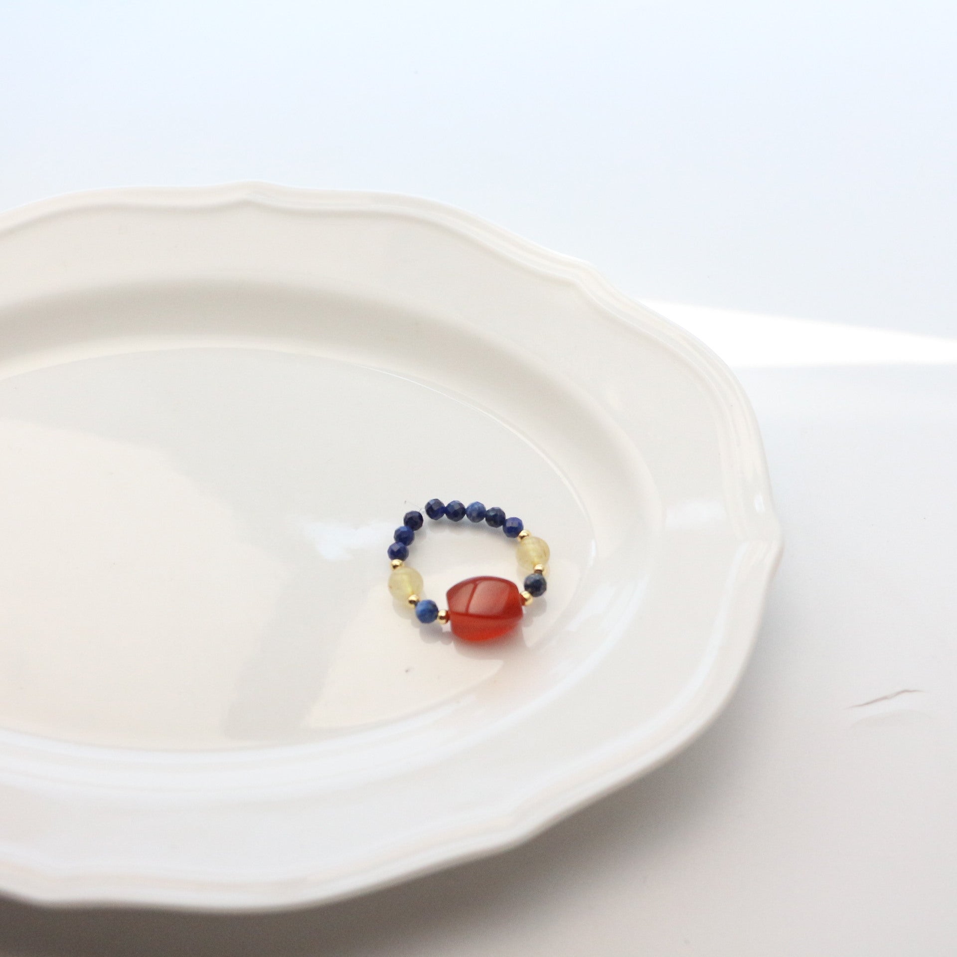 Lapis Lazuli Agate Ring Set – blue lapis lazuli ring with square red agate center and gold accents, white plate, adjustable crystal ring