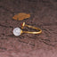Hetian Jade Clouds Ring – side view white jade bead on gold band with dark textured background and gold leaf, jade ring