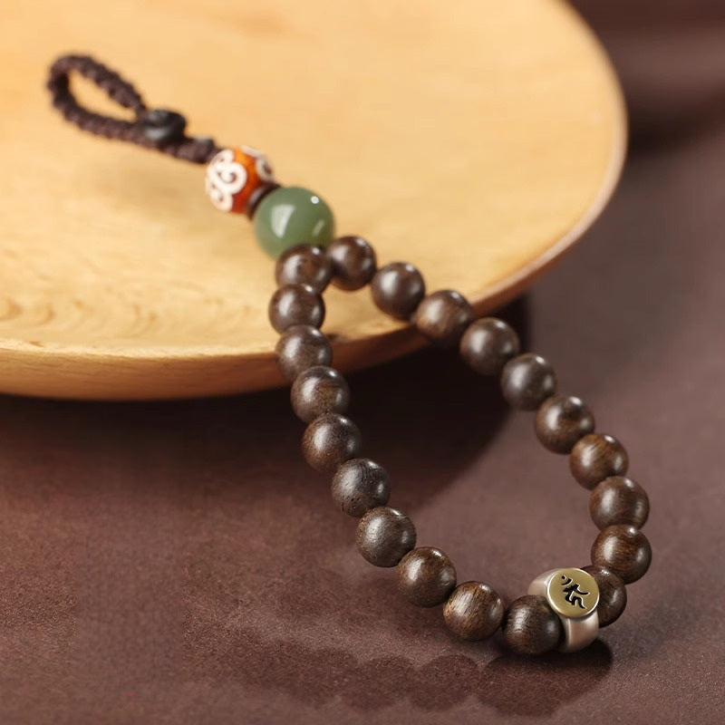 Hetian Jade & Agarwood Zodiac Buddha Keychain – Dark agarwood beads with green Hetian jade, Dzi-pattern bead, and Sanskrit metal plate on wood