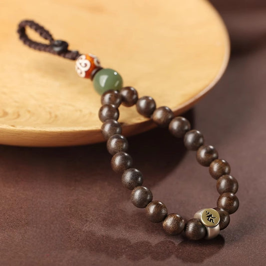 Hetian Jade & Agarwood Zodiac Buddha Keychain – Dark agarwood beads with green Hetian jade, Dzi-pattern bead, and Sanskrit metal plate on wood