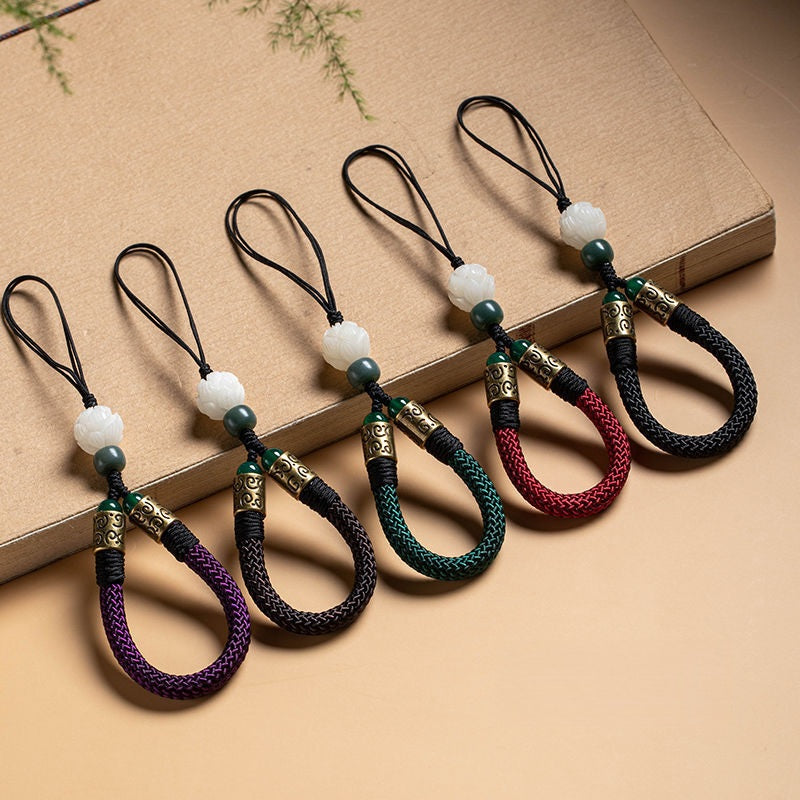 Lotus Bodhi Lanyard – Five color variants arranged on vintage book, green black red purple brown, multi-color lotus lanyard collection