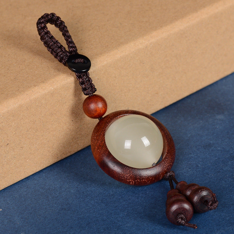 Feng Shui Sandalwood Keychain with Luminous Bead – Clean white background product shot of Bloodwood version with braided cord