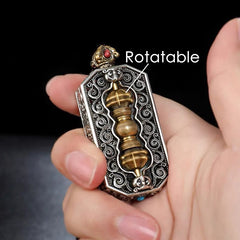 Dorje Vajra Rope Pendant – Handheld view of spinning vajra centerpiece in silver frame, Buddhist jewelry