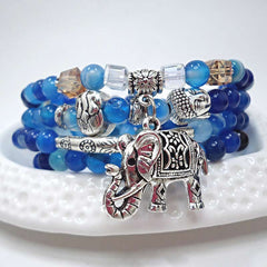 Natural Agate Elephant Buddha Bracelet – blue agate stacked on white dish with elephant charm, detail