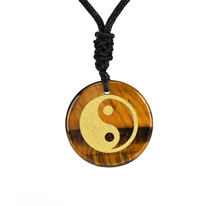 Yin Yang Crystal Necklace – Tiger eye round pendant with gold yin-yang on black cord, natural brown and gold banded stone wit