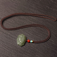 Cyan Jade Lotus Flower Necklace – full cord necklace with carved lotus on dark stone, mindful