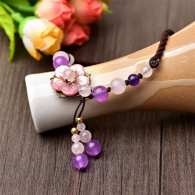 Amethyst Rose Quartz Crystal Charm Healing Anklet - Black stone yin-yang carved bracelet flat lay on white background, gol...