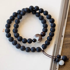 Tibetan Cypress Bodhi Lotus Bracelet - double-wrap black beads on open book with lotus focal, zen