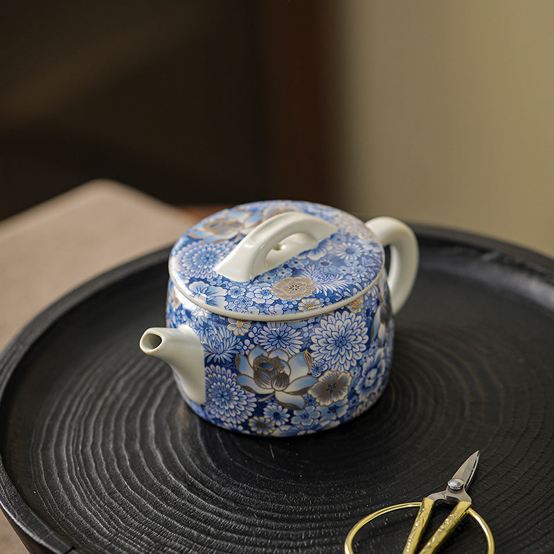 Lotus Chrysanthemum Ceramic Teapot - Blue-white floral with gold accents on wooden tray, premium gongfu