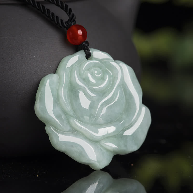 Lotus Pattern Jade Prosperity Necklace - carved jade rose with red bead on dark surface, jade necklace