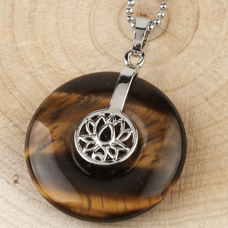 Crystal Amethyst Pink Crystal Lotus Necklace – Tiger eye and lapis lazuli lotus donut pendants paired on wood, warm and cool gemstone duo