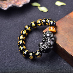 Obsidian PiXiu Rainbow Obsidian Wealth Bracelet – Black obsidian bracelet with PiXiu and tiger eye on wood