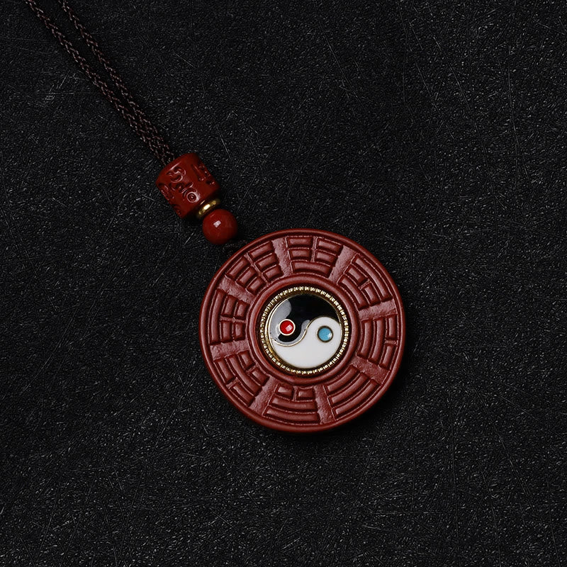 Cinnabar Bagua Rotatable Yin Yang Necklace – Red cinnabar Yin-Yang Bagua amulet, black background, Taoist necklace