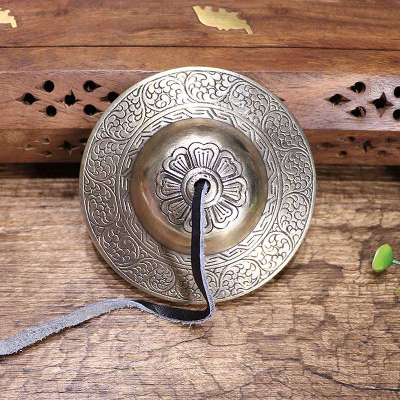 Tibetan Tingsha Bells – Top-down view of single cymbal with lotus and geometric border, sound healing bells
