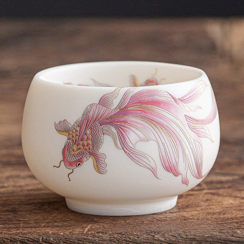 Koi Fish Porcelain Cup - single cup on stone surface, traditional Chinese tea aesthetic