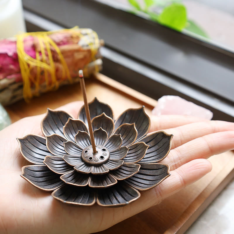 Six-Hole Lotus Incense Burner resting on open palm, vintage bronze flower, serene