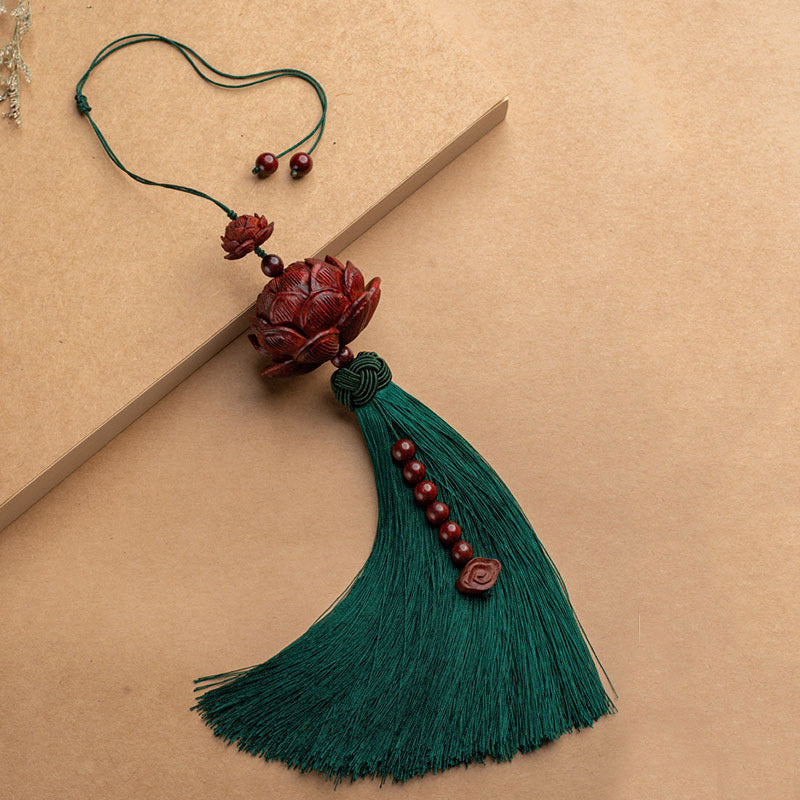 Red Sandalwood Lotus Tassel - green silk tassel with lotus and ruyi charm on kraft paper