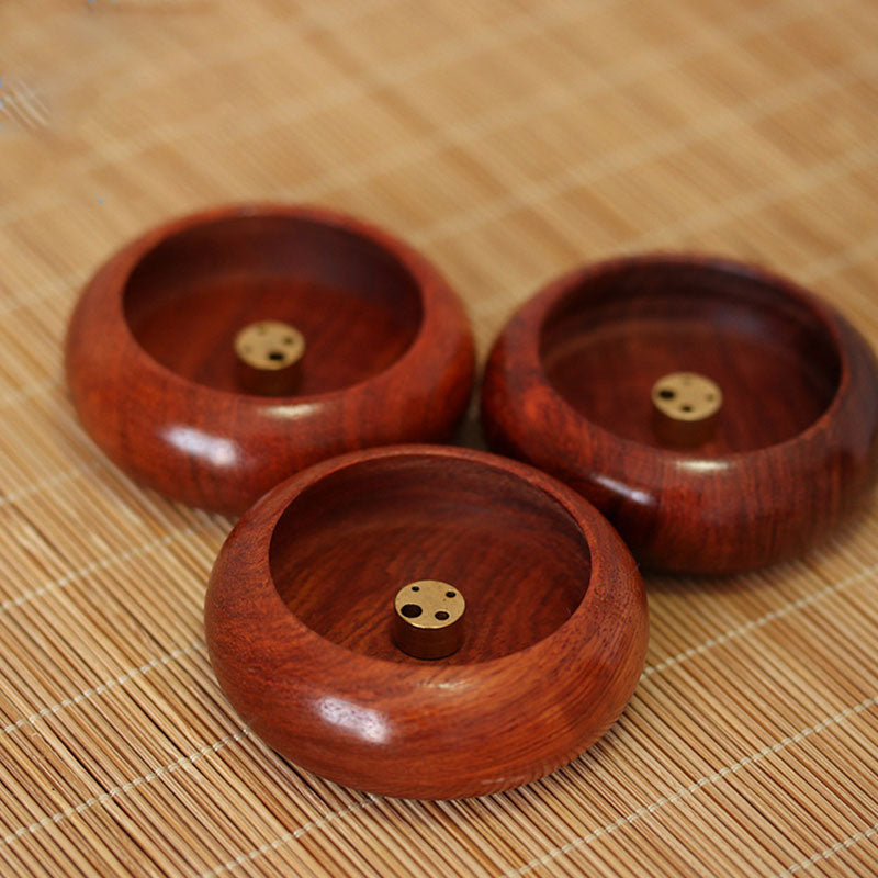 Rosewood Incense Burner – three bowls with brass inserts on bamboo mat, front holder in sharp focus, peaceful
