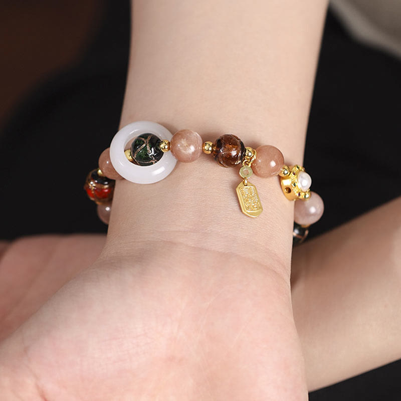 Liuli Glass Prayer Wheel Bracelet – Wrist close-up showing mixed stone beads and gold tag charm