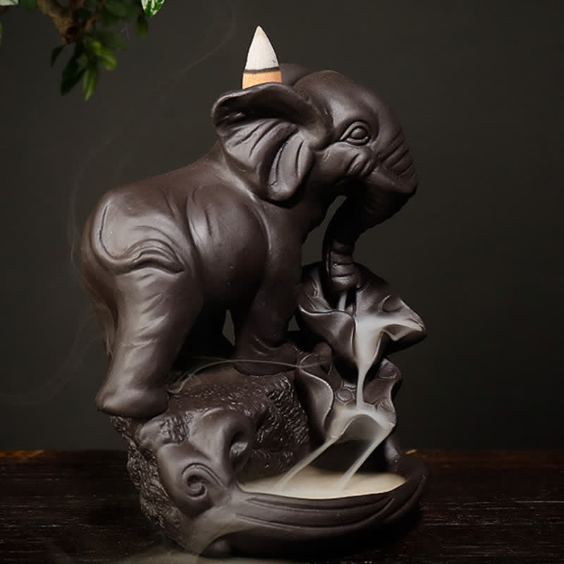 Baby Elephant Incense Burner – Side angle with playful raised leg pose and flowing smoke on lotus leaf base, zen decor