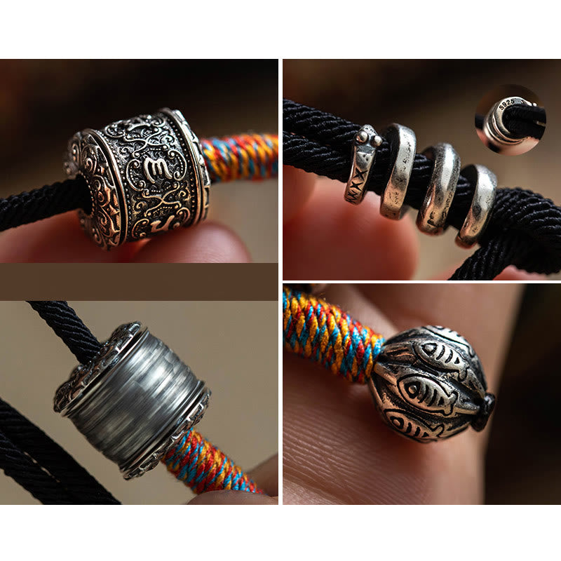 Tibetan Om Mani Padme Hum Wrap Bracelet – Coiled black cord bracelet with silver mantra bead on beige fabric with dried leaf accents, warm lighting