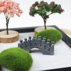 Buddha Zen Garden Decoration - Close-up miniature stone bridge with moss balls and decorative cherry blossom trees