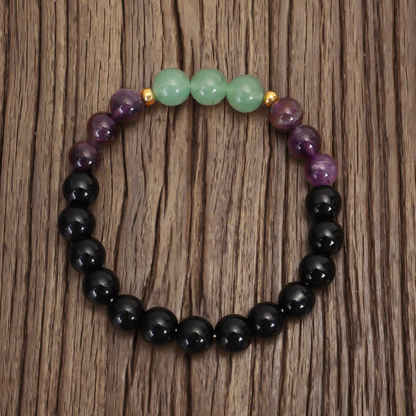 Amethyst Aventurine Lotus Mala - Color-block gemstone bracelet with gold accents on rustic wood, boho healing